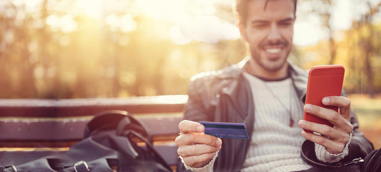 man with a credit card and mobile phone